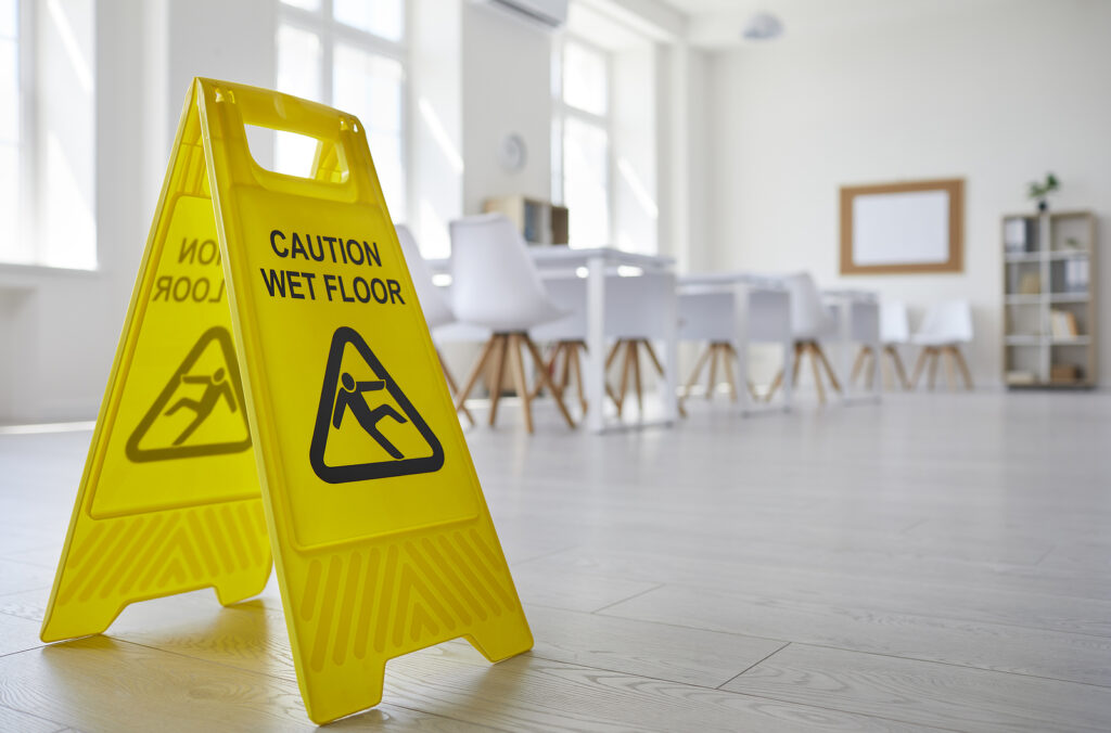 Yellow Sign With The Inscription Caution Wet Floor Which Was Put