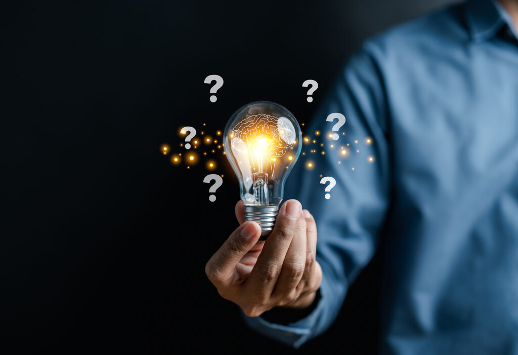 Businessman hand holding light bulb with brain into smart, creative, idea thinking to innovation brainstorm and imagination learning educate concept.