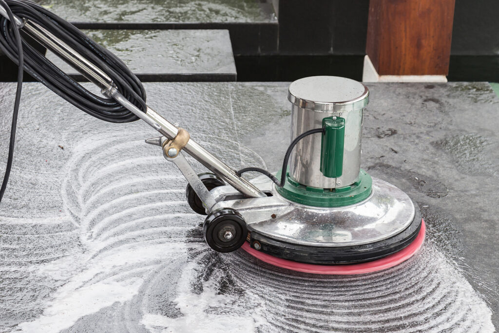 Strip and waxing of commercial office flooring with the proper machinery. Professionals cleaning floors in a high traffic area.