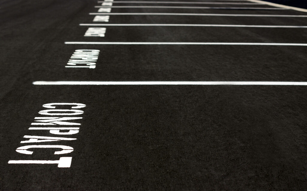 Row of parking spaces for compact cars ** Note: Shallow depth of field